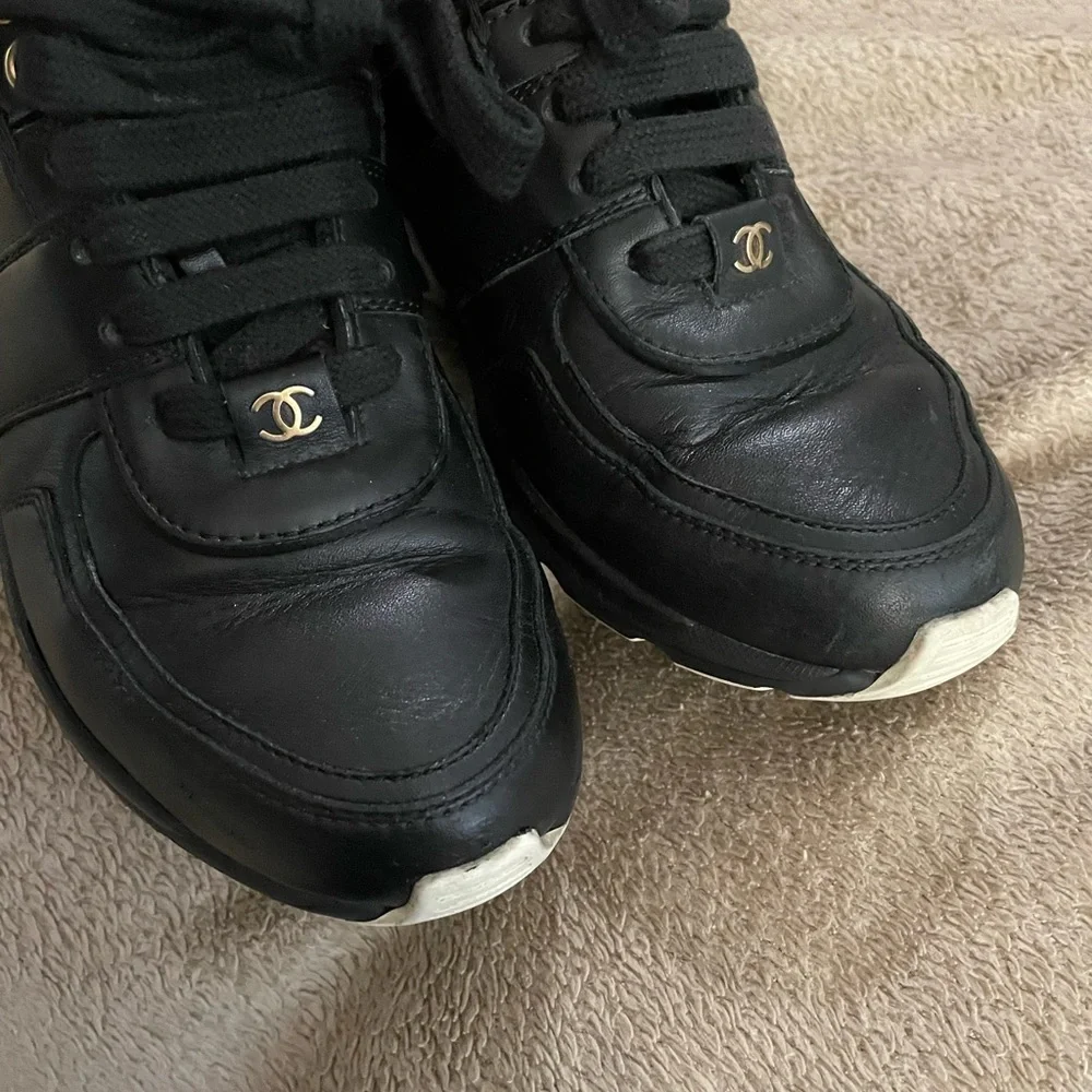 CHANEL Black Leather Low-Top Sneakers with White Accent